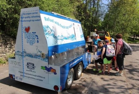 kids at water wagon refill station with multiple fountains