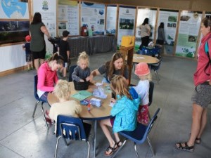 kids and adults going through the conservation exhibit displays and making crafts