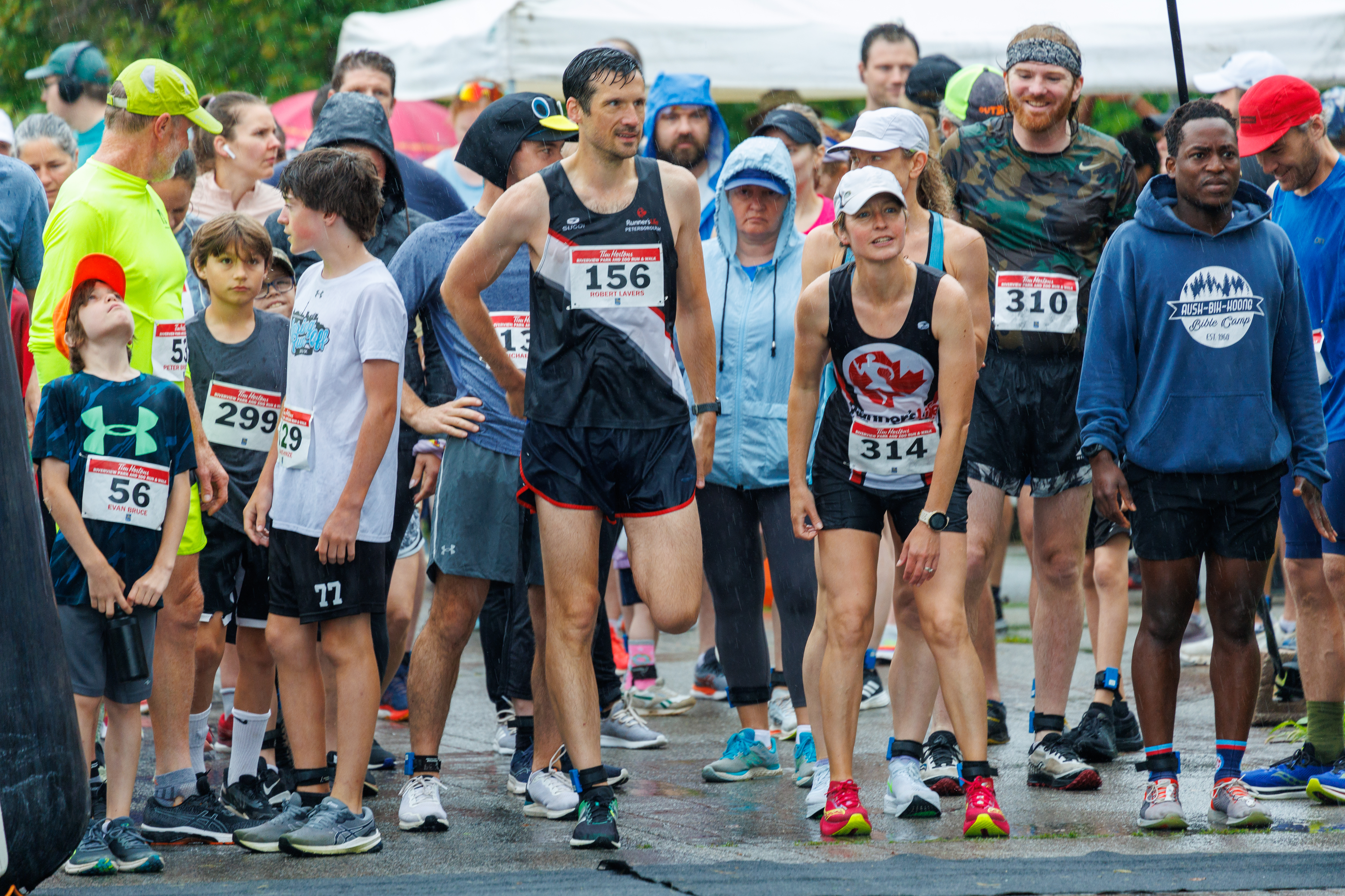 Group of runners at the starting line in wet weather