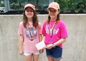 two girls posing with medals