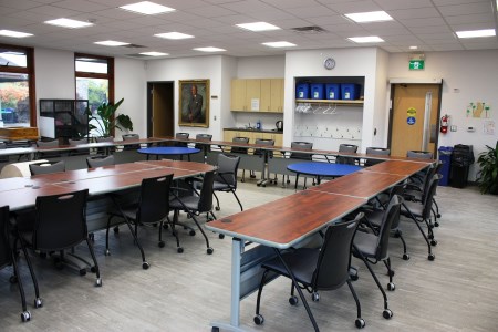 groups of tables and chairs set up in a room