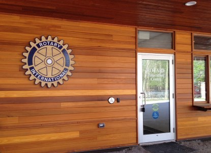 door on side of building with rotary logo on the outside wall